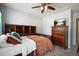 Comfortable bedroom featuring a queen bed with a wooden headboard and dresser with TV at 4003 Coachman Ct, Cumming, GA 30040