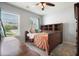 Inviting bedroom with natural light, a cozy bed, and a wooden dresser with ample storage at 4003 Coachman Ct, Cumming, GA 30040