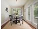Cozy dining area with a modern table set, flooded with natural light from a large window and French doors at 4003 Coachman Ct, Cumming, GA 30040