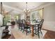 Spacious dining room with wood table, black chairs, and large windows at 4003 Coachman Ct, Cumming, GA 30040