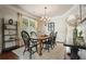 Dining room featuring hardwood floors, a chandelier, and ladder bookcase at 4003 Coachman Ct, Cumming, GA 30040