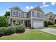 Two-story house with a two-car garage, mature landscaping and curb appeal at 4003 Coachman Ct, Cumming, GA 30040
