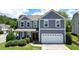 Inviting two-story home features a two-car garage and manicured front lawn at 4003 Coachman Ct, Cumming, GA 30040
