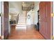 Elegant foyer featuring gleaming hardwood floors and a staircase with iron railing at 4003 Coachman Ct, Cumming, GA 30040