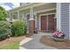 Charming covered front porch with decorative plants by the double doors at 4003 Coachman Ct, Cumming, GA 30040