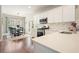 Bright kitchen with white cabinets, stainless steel appliances, and adjacent breakfast nook with seating at 4003 Coachman Ct, Cumming, GA 30040