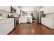 Modern kitchen featuring stainless steel appliances, white cabinetry, hardwood flooring and an open layout at 4003 Coachman Ct, Cumming, GA 30040