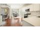Bright kitchen with white cabinets, stainless steel appliances, and adjacent breakfast nook with hardwood floors at 4003 Coachman Ct, Cumming, GA 30040