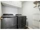 Efficient laundry room featuring sleek new gray front load washer and dryer, plus storage at 4003 Coachman Ct, Cumming, GA 30040