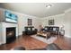 Spacious living room with fireplace, hardwood floors, and leather furnishings at 4003 Coachman Ct, Cumming, GA 30040