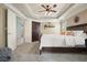Main bedroom with tray ceiling, ceiling fan, wardrobe, and plenty of natural lighting at 4003 Coachman Ct, Cumming, GA 30040