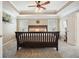 Spacious main bedroom with a ceiling fan, tray ceiling, and neutral-colored walls at 4003 Coachman Ct, Cumming, GA 30040