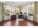 Bright home office with hardwood floors, neutral walls, and two large windows at 4003 Coachman Ct, Cumming, GA 30040