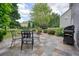 Paver patio features seating, a grill, and overlooks the well-maintained backyard at 4003 Coachman Ct, Cumming, GA 30040