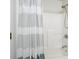 Clean bathroom shower with gray and white striped shower curtain and brushed chrome fixtures at 4003 Coachman Ct, Cumming, GA 30040
