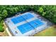 Aerial view of community tennis courts. Offers residents social and recreational opportunities with nearby pool and green space at 4003 Coachman Ct, Cumming, GA 30040