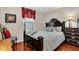 Comfortable bedroom with a dark wood frame bed, cherry floors, and decorative window treatment at 4081 Riverlook Se Pkwy # 13, Marietta, GA 30067