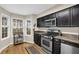 Stylish kitchen offers modern appliances, dark cabinetry, and a breakfast nook with natural light at 4081 Riverlook Se Pkwy # 13, Marietta, GA 30067