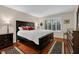 Spacious bedroom featuring a dark wood bed set and plantation shutters for privacy at 4081 Riverlook Se Pkwy # 13, Marietta, GA 30067
