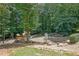 Community playground featuring wooden play structure, dome climber, and green surroundings at 4081 Riverlook Se Pkwy # 13, Marietta, GA 30067