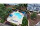 Aerial view of a community pool with lounge chairs and manicured landscaping at 4081 Riverlook Se Pkwy # 13, Marietta, GA 30067