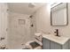 Small bathroom with marble-look tile in shower and blue vanity at 440 Forestgate Ct, Atlanta, GA 30350
