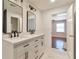 Bathroom with double sink vanity, sleek fixtures, and marble tile flooring at 440 Forestgate Ct, Atlanta, GA 30350