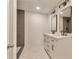 Bathroom featuring dual sink vanity with a shower visible through the door at 440 Forestgate Ct, Atlanta, GA 30350