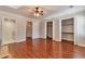 Spacious bedroom with hardwood floors, ceiling fan, and ample closet space at 440 Forestgate Ct, Atlanta, GA 30350