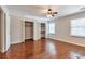 Bright bedroom featuring hardwood floors, two closets, and a large window at 440 Forestgate Ct, Atlanta, GA 30350