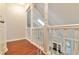 Open hallway with decorative railing overlooking the living area and fireplace at 440 Forestgate Ct, Atlanta, GA 30350