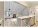 Open kitchen featuring stainless steel appliances, breakfast bar, and modern flooring at 440 Forestgate Ct, Atlanta, GA 30350