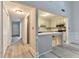 Bright kitchen featuring white cabinets, modern appliances, and an adjacent breakfast bar at 440 Forestgate Ct, Atlanta, GA 30350