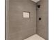 Shower with modern gray tiling, niche, and matte black fixtures at 440 Forestgate Ct, Atlanta, GA 30350