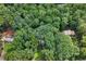 Aerial view of a private, wooded lot with mature trees and beautiful landscaping at 980 Hightower Trl, Sandy Springs, GA 30350