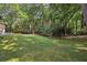 A spacious backyard features a lush lawn and a partially obscured house at 980 Hightower Trl, Sandy Springs, GA 30350
