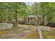 A classic red brick home features white columns, shutters, and a manicured lawn at 980 Hightower Trl, Sandy Springs, GA 30350