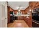 Traditional kitchen with wood cabinets, appliances, and hardwood floors at 980 Hightower Trl, Sandy Springs, GA 30350