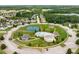 Aerial view of community amenities: a pool, tennis court, recreation center and other neighborhood landscaping at 1212 Ithaca Dr, Mcdonough, GA 30253