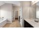 This bathroom has double doors, a separate bathtub and a long vanity at 1212 Ithaca Dr, Mcdonough, GA 30253
