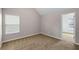 Neutral bedroom features a bright window with blinds and neutral walls and carpet at 1212 Ithaca Dr, Mcdonough, GA 30253