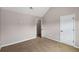 Neutral-toned bedroom with tan carpet, a white door, and a vaulted ceiling at 1212 Ithaca Dr, Mcdonough, GA 30253