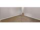 Neutral-toned bedroom with tan carpet, a door, and neutral walls and baseboards at 1212 Ithaca Dr, Mcdonough, GA 30253