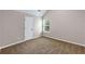 Neutral bedroom features a bright window with blinds and neutral walls and carpet at 1212 Ithaca Dr, Mcdonough, GA 30253