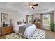 This bedroom features a neutral palette, tray ceiling and a patterned area rug at 1212 Ithaca Dr, Mcdonough, GA 30253