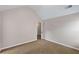 Neutral-toned bedroom with tan carpet, a white door, and a vaulted ceiling at 1212 Ithaca Dr, Mcdonough, GA 30253