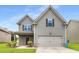 Charming two-story home with gray siding, a well-manicured lawn, and an attached two-car garage at 1212 Ithaca Dr, Mcdonough, GA 30253