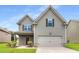 Charming two-story home with gray siding, a well-manicured lawn, and an attached two-car garage at 1212 Ithaca Dr, Mcdonough, GA 30253