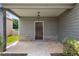 Inviting front porch featuring brick accents, neutral siding, and a classic hanging lantern at 1212 Ithaca Dr, Mcdonough, GA 30253