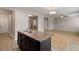 Kitchen island with double sink open to living area at 1212 Ithaca Dr, Mcdonough, GA 30253